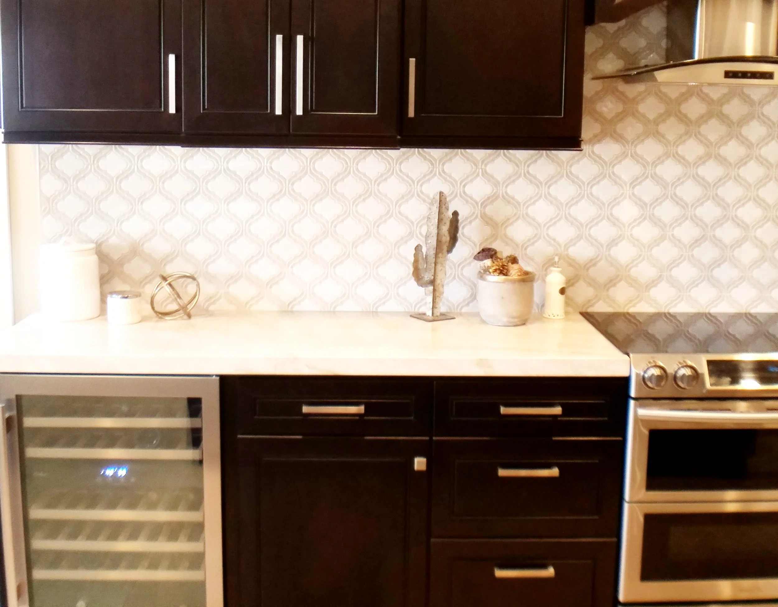 Decoriam installed kitchen with espresso cabinetry and a pale quartzite island